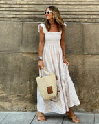 Women flutter sleeve maxi dress with fitted bodice and flowing skirt