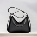 Women's genuine leather handbag with top handles, gold hardware and twist-lock closure