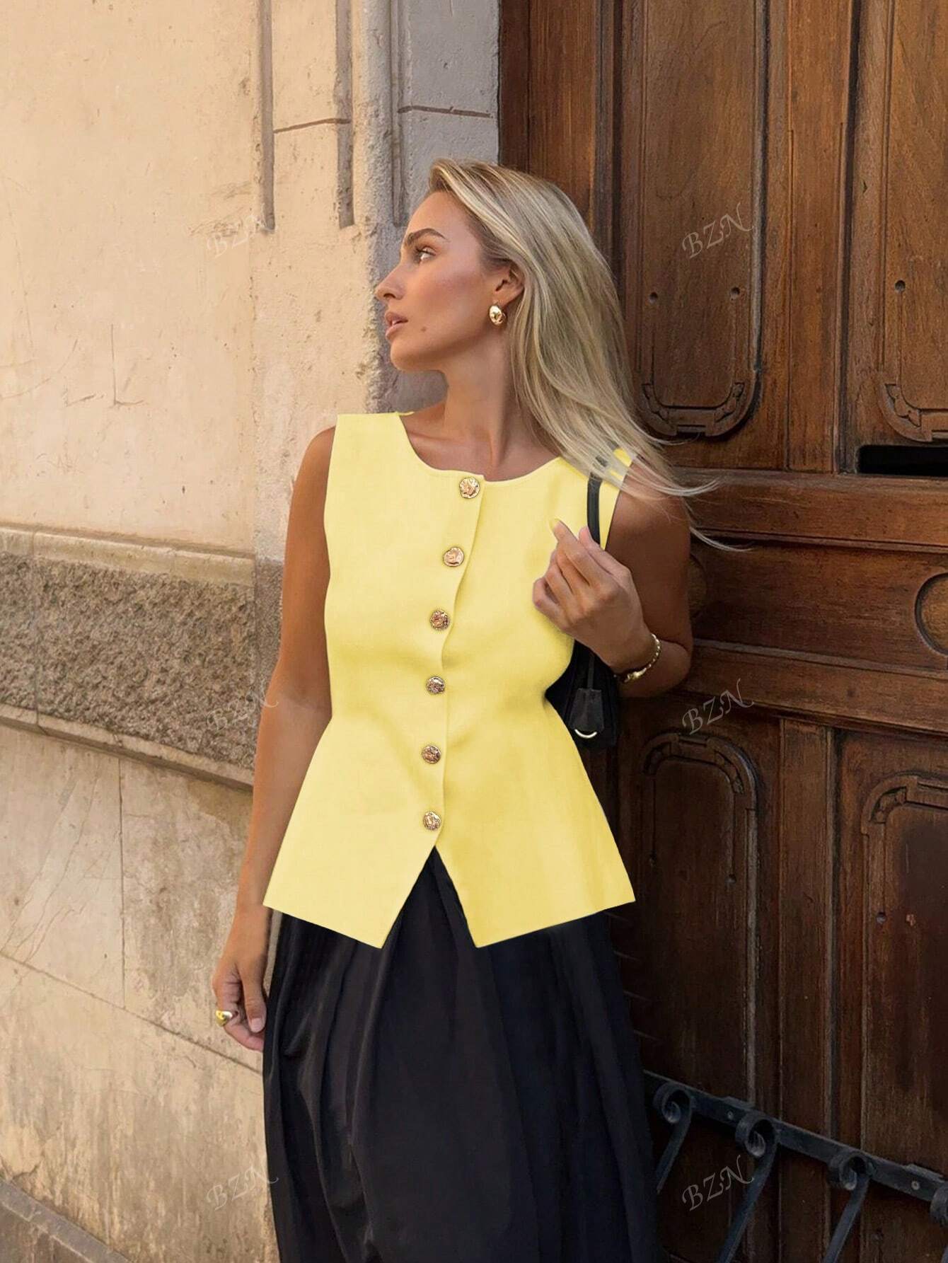 Women's sleeveless button-front peplum vest with gold buttons, tailored fit