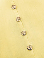 Women's sleeveless button-front peplum vest with gold buttons, tailored fit