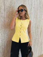 Women's sleeveless button-front peplum vest with gold buttons, tailored fit