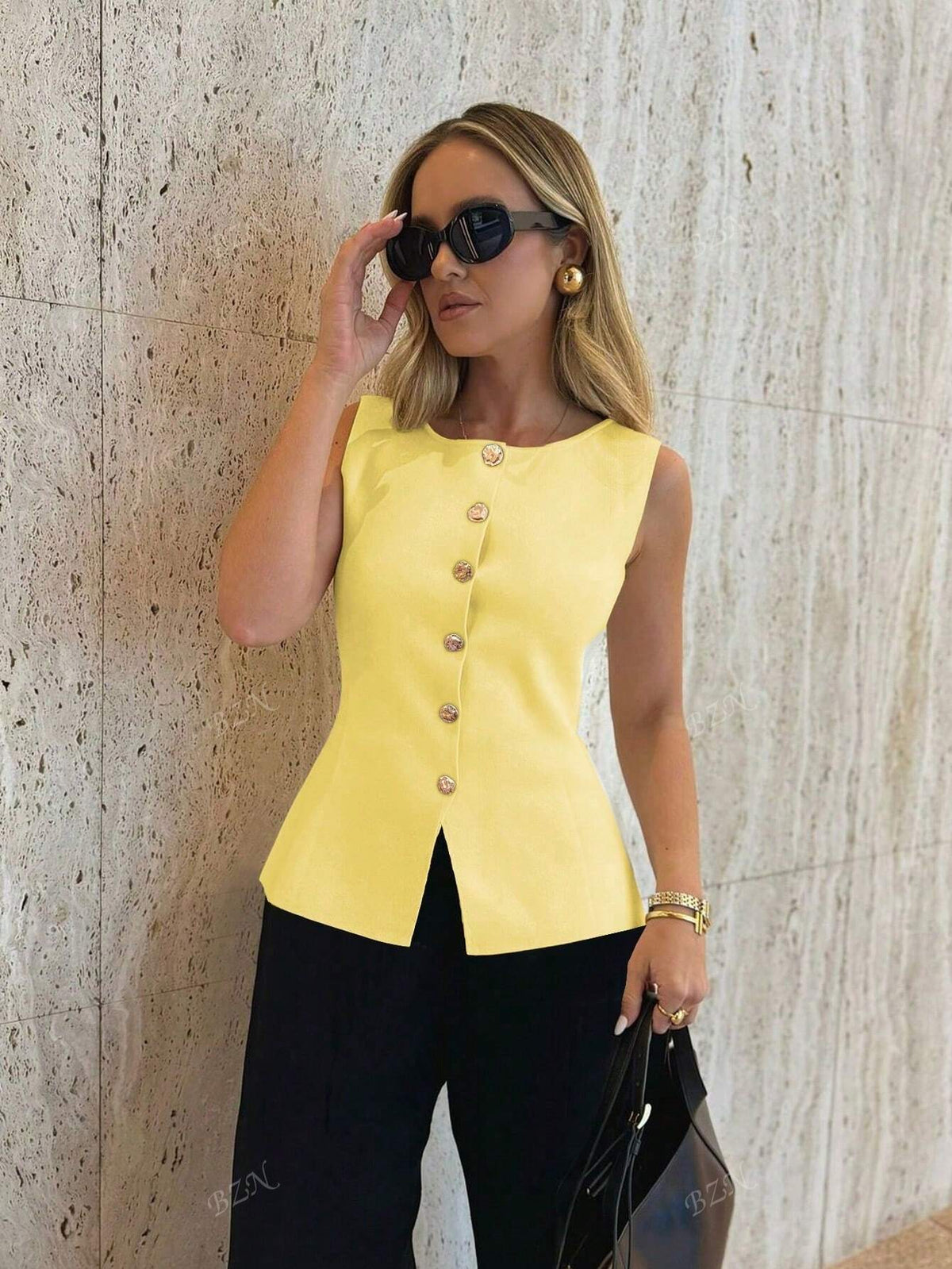 Women's sleeveless button-front peplum vest with gold buttons, tailored fit