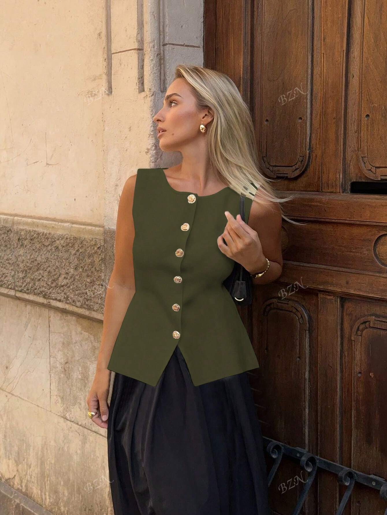 Women's sleeveless button-front peplum vest with gold buttons, tailored fit