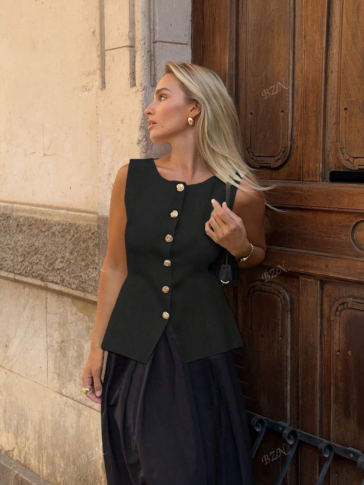 Women's sleeveless button-front peplum vest with gold buttons, tailored fit