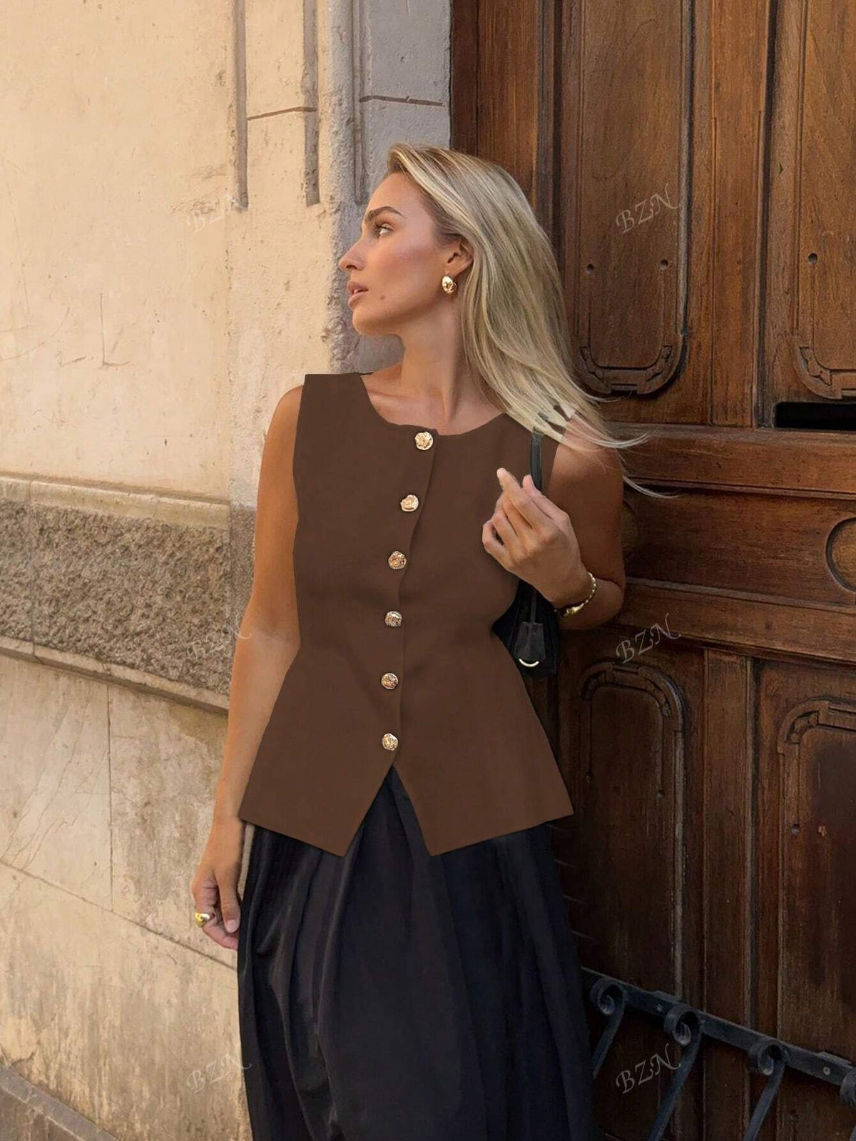 Women's sleeveless button-front peplum vest with gold buttons, tailored fit