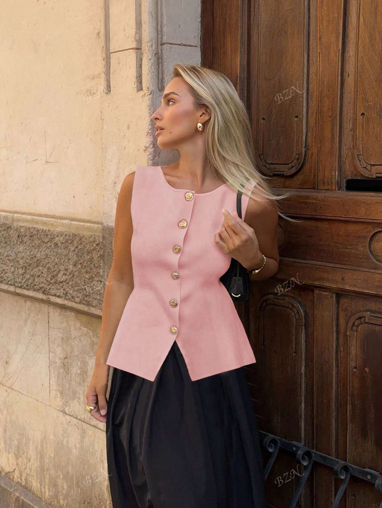Women's sleeveless button-front peplum vest with gold buttons, tailored fit