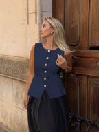 Women's sleeveless button-front peplum vest with gold buttons, tailored fit
