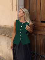 Women's sleeveless button-front peplum vest with gold buttons, tailored fit