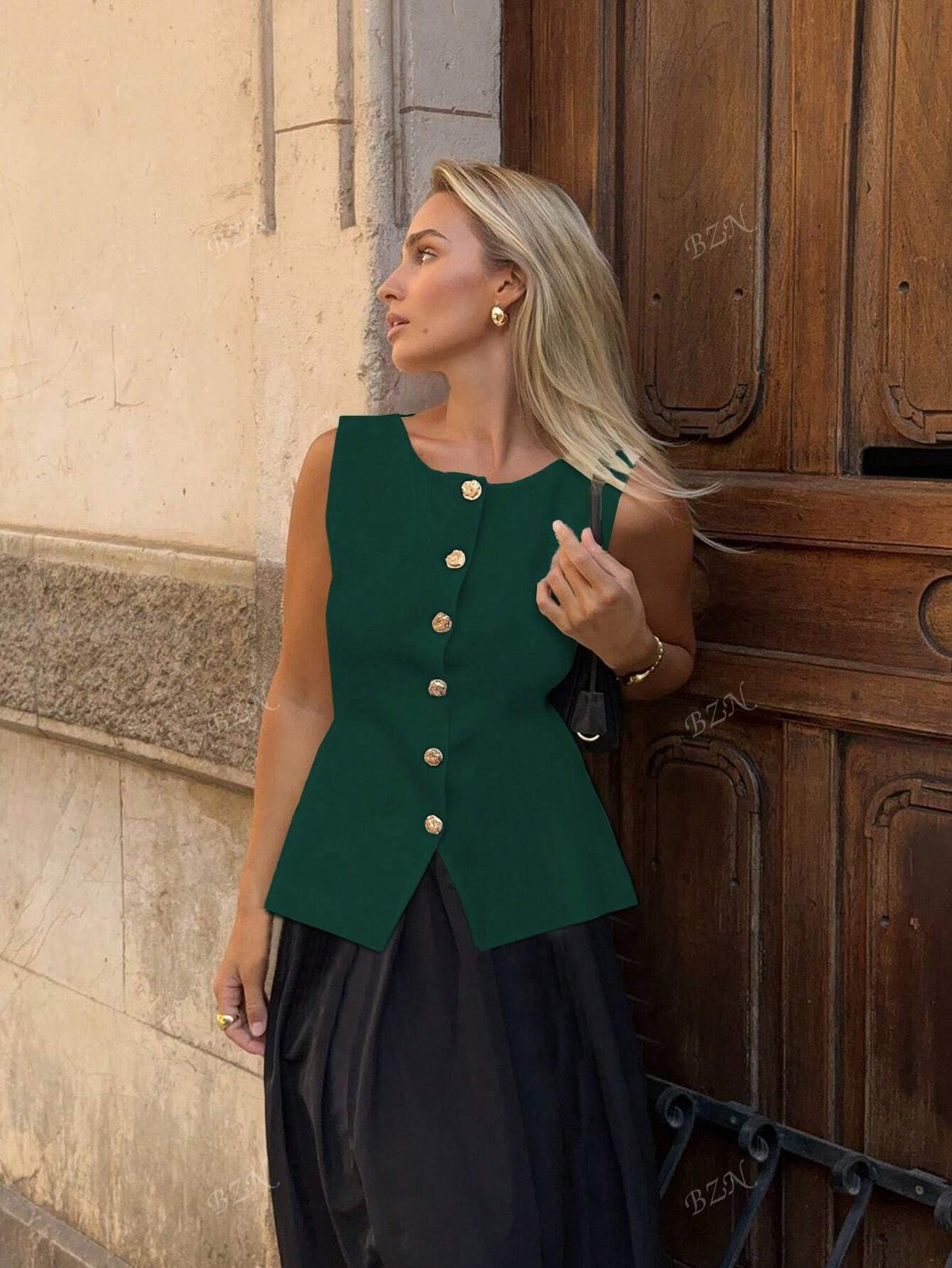 Women's sleeveless button-front peplum vest with gold buttons, tailored fit