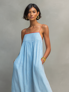 Women's striped maxi dress with spaghetti straps and red trim detail