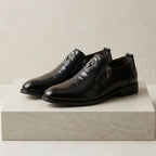 Men's leather dress shoes with lion embossed detail and side zip closure