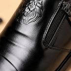 Men's leather dress shoes with lion embossed detail and side zip closure