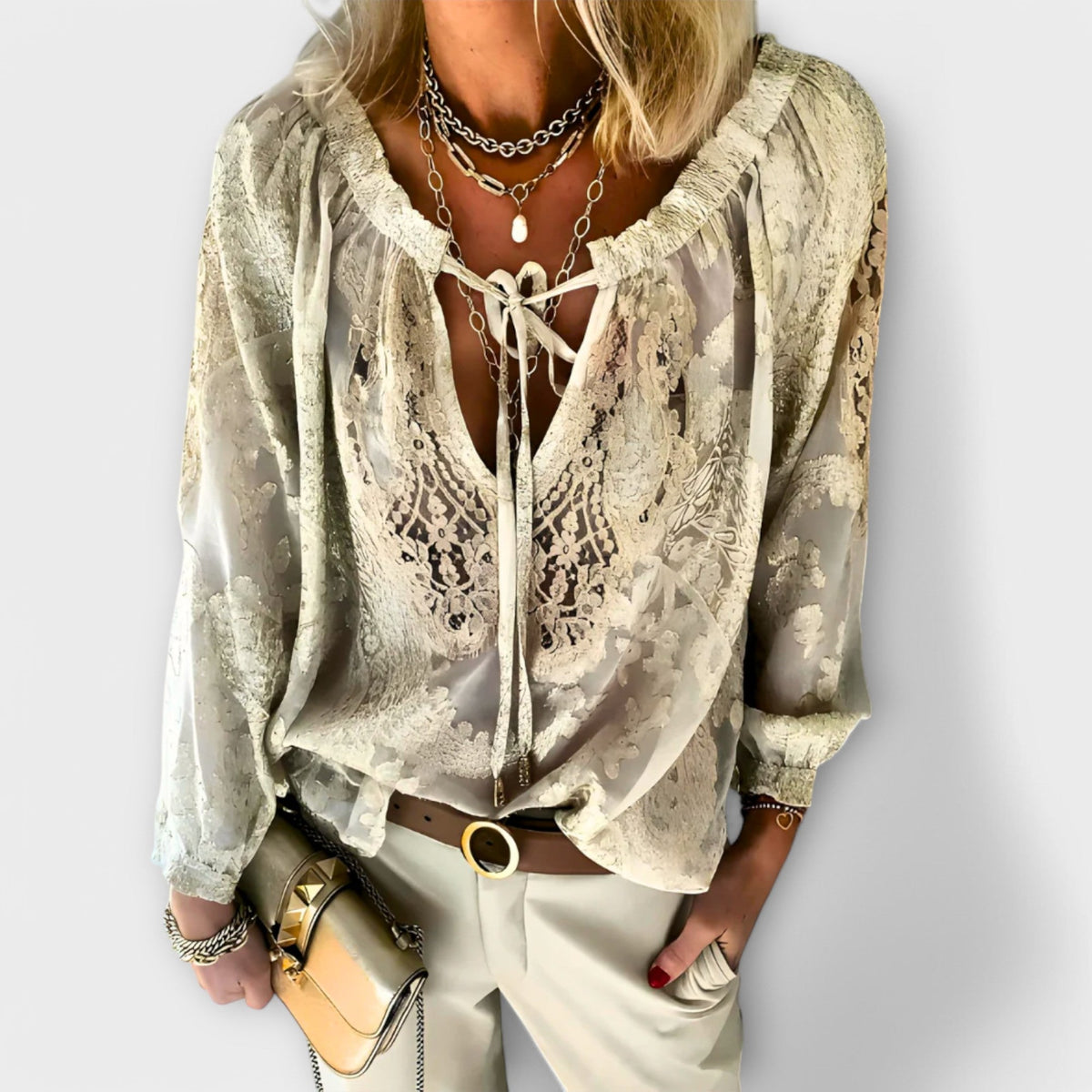 Women's embroidered blouse with deep V-neck, tie strings, long flowy sleeves and eyelet detail