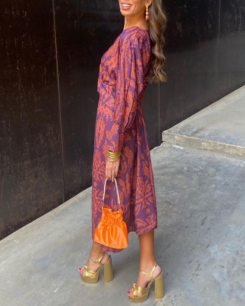 Women's boho maxi dress with V-neckline and twist front detail, full-length boho print