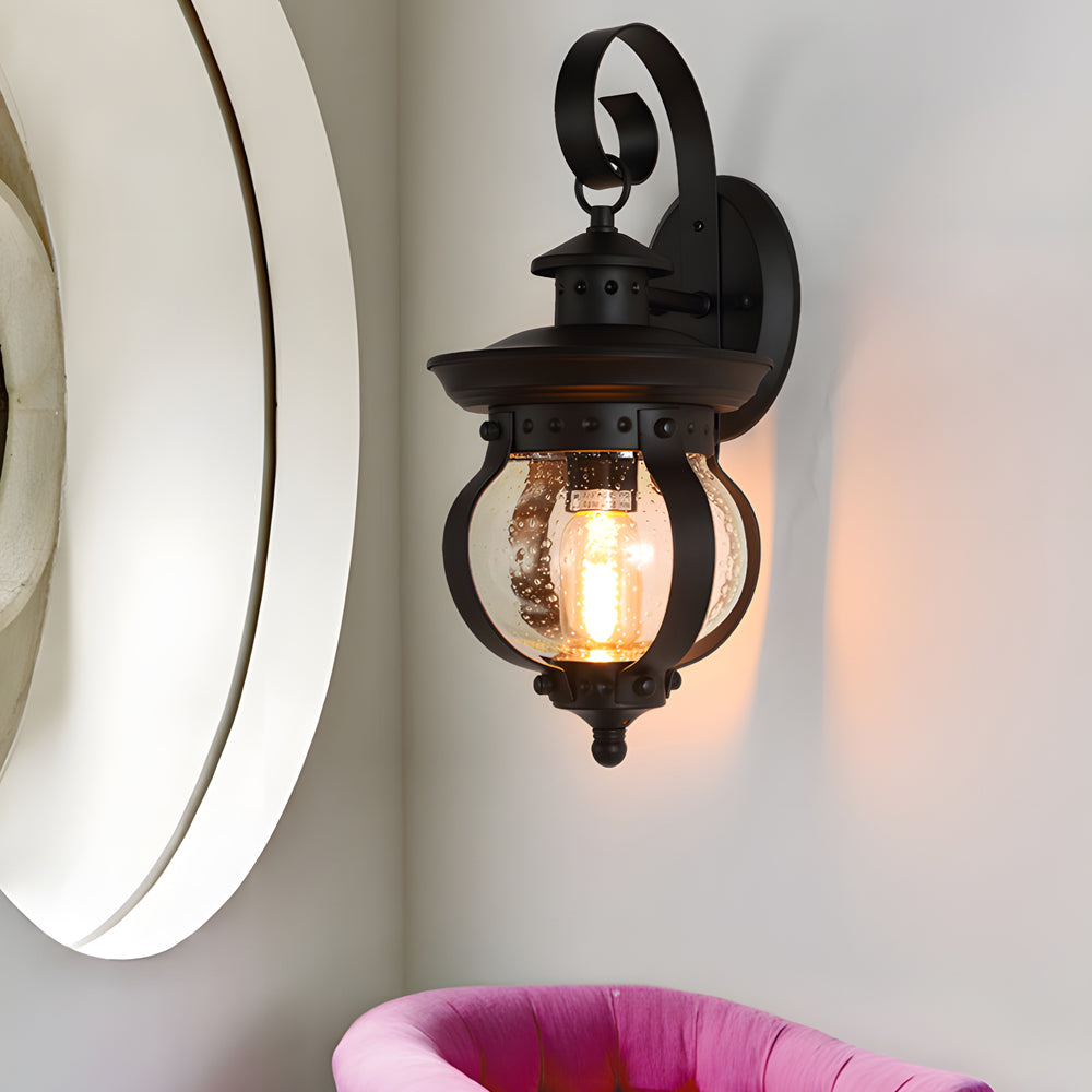 Outdoor wall lantern black seeded glass globe LED curved arm 1-light