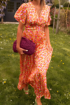 Women's floral maxi dress with deep V-neckline and fitted waist, summer style