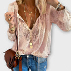 Women's embroidered blouse with deep V-neck, tie strings, long flowy sleeves and eyelet detail