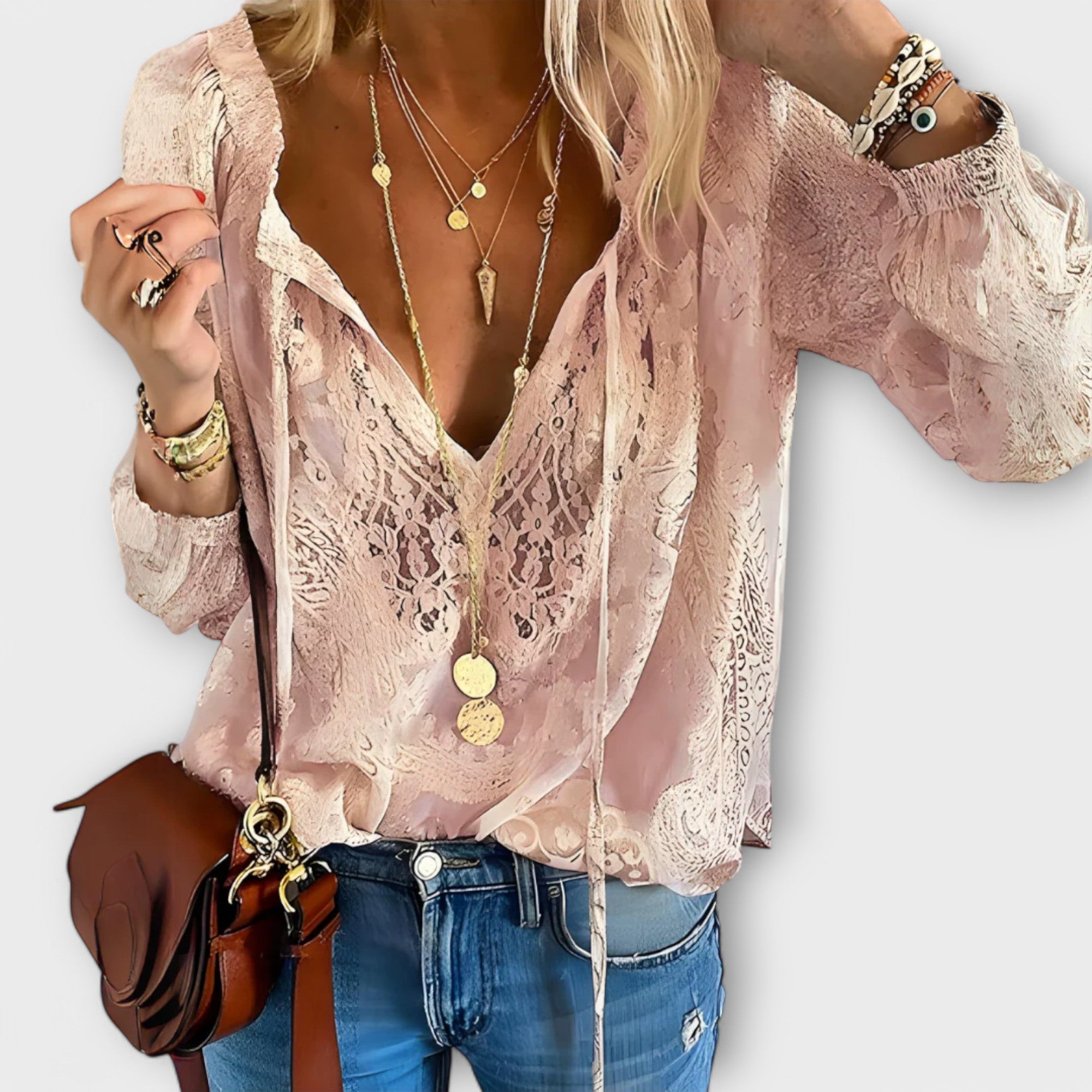 Women's embroidered blouse with deep V-neck, tie strings, long flowy sleeves and eyelet detail