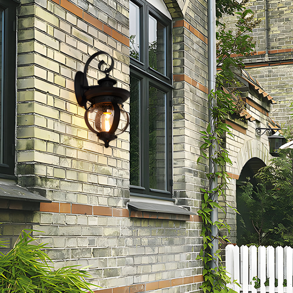 Outdoor wall lantern black seeded glass globe LED curved arm 1-light