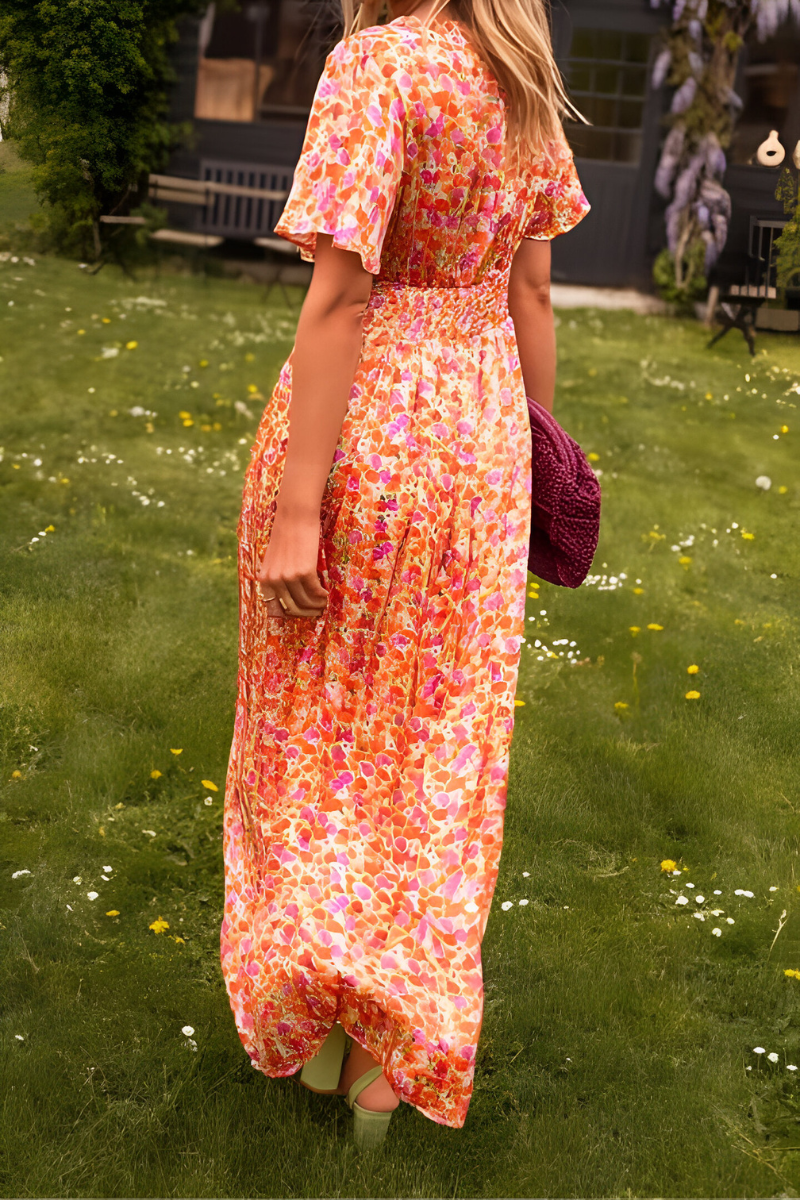 Women's floral maxi dress with deep V-neckline and fitted waist, summer style