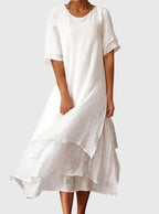 Women's elegant dress with open neckline and fluid cut, available in multiple colours