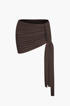 Women's two-piece set with one-shoulder top and draped mini skirt, asymmetric knot detail