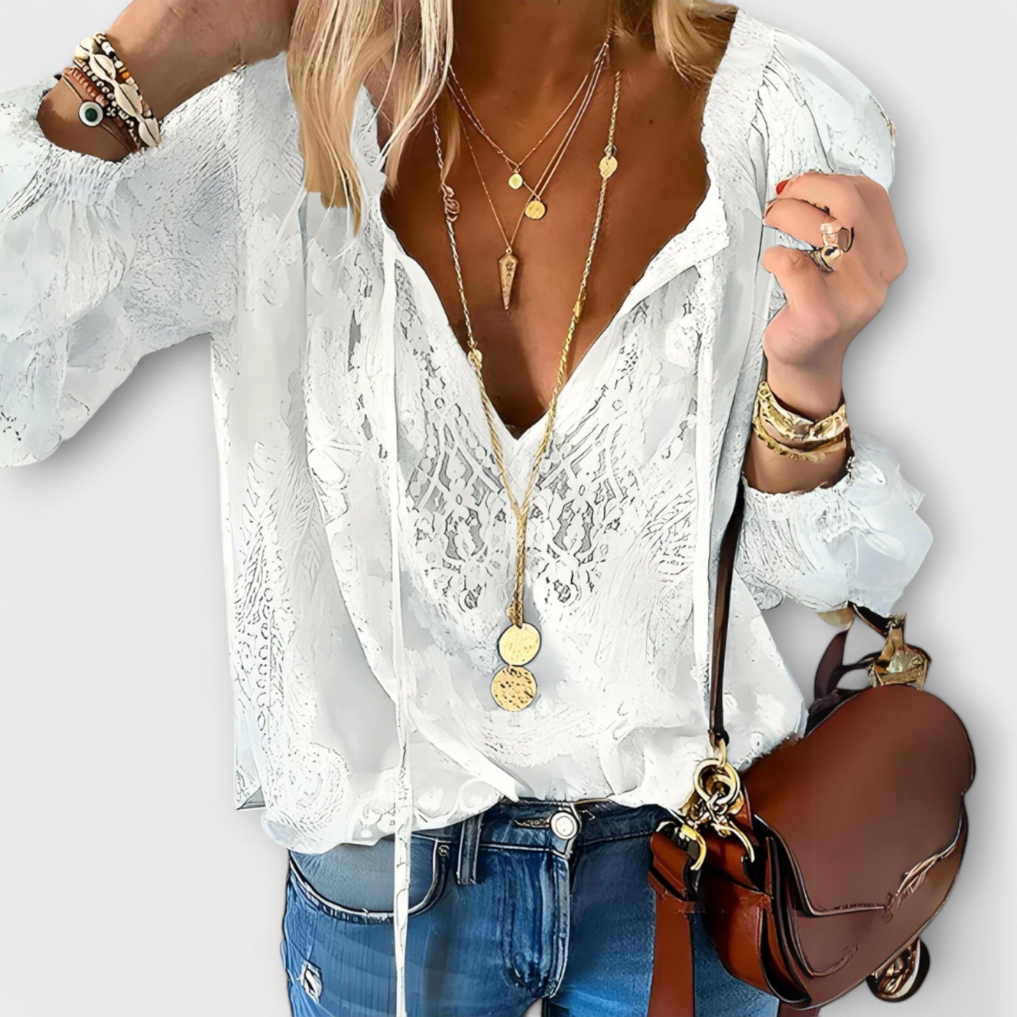 Women's embroidered blouse with deep V-neck, tie strings, long flowy sleeves and eyelet detail