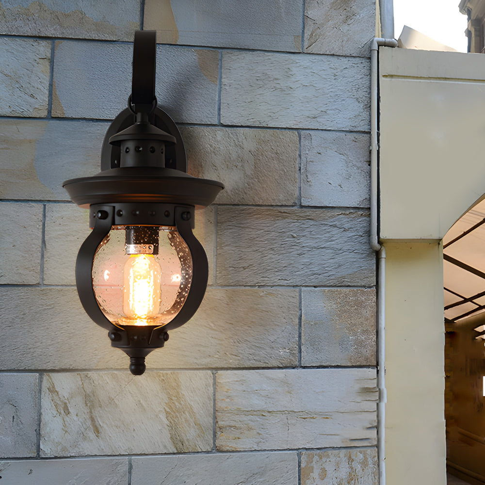 Outdoor wall lantern black seeded glass globe LED curved arm 1-light