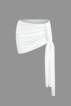 Women's two-piece set with one-shoulder top and draped mini skirt, asymmetric knot detail