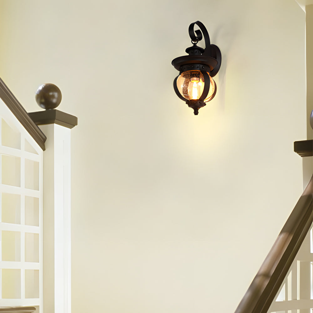 Outdoor wall lantern black seeded glass globe LED curved arm 1-light