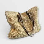 Women woven straw shoulder bag with firm top handle in natural texture