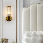 Modern wall lamp with cylindrical ribbed clear glass shade in chrome or gold finish