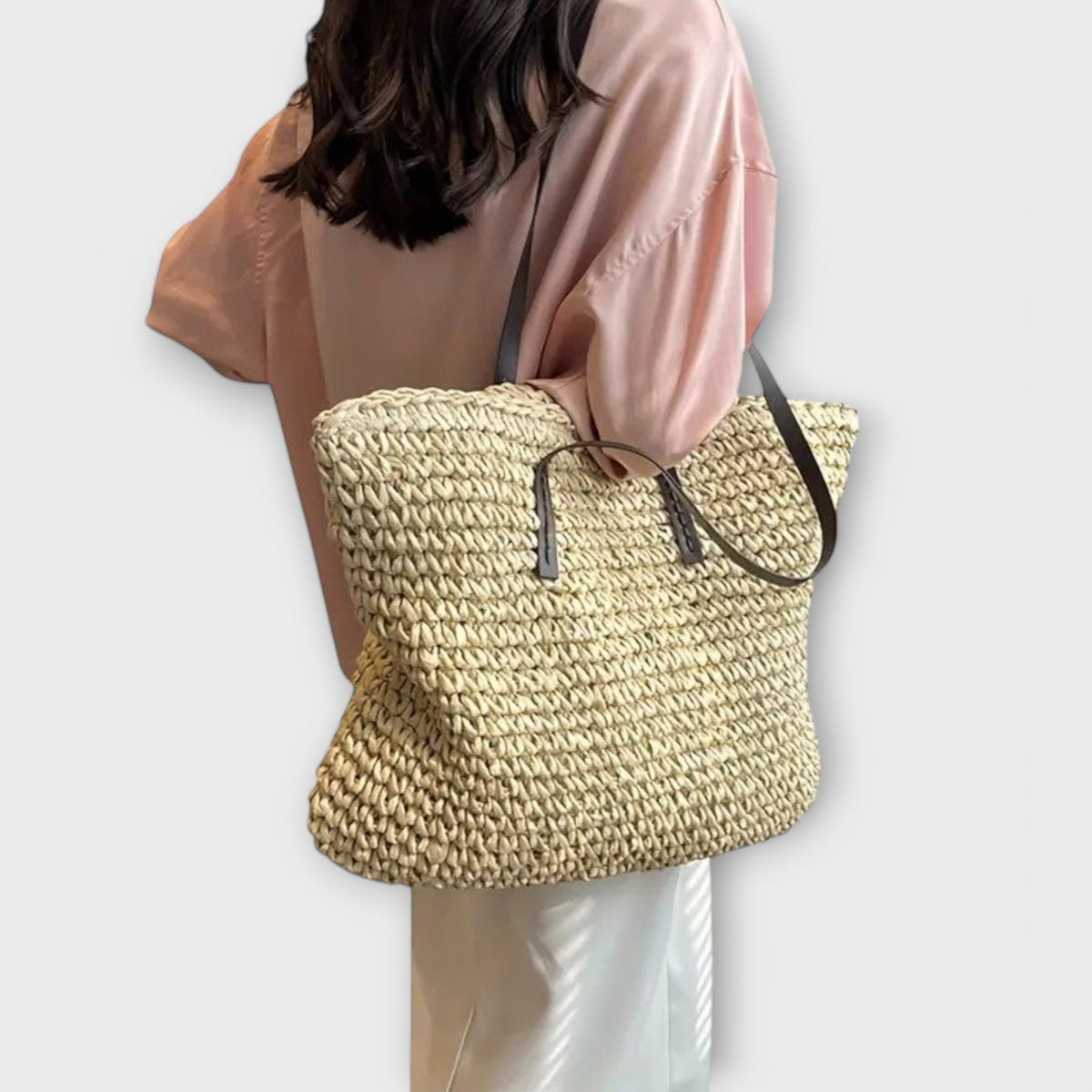Women woven straw shoulder bag with firm top handle in natural texture
