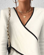 Women's white V-neck sweater with comfortable fitted cut and timeless style
