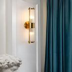 Modern wall lamp with cylindrical ribbed clear glass shade in chrome or gold finish