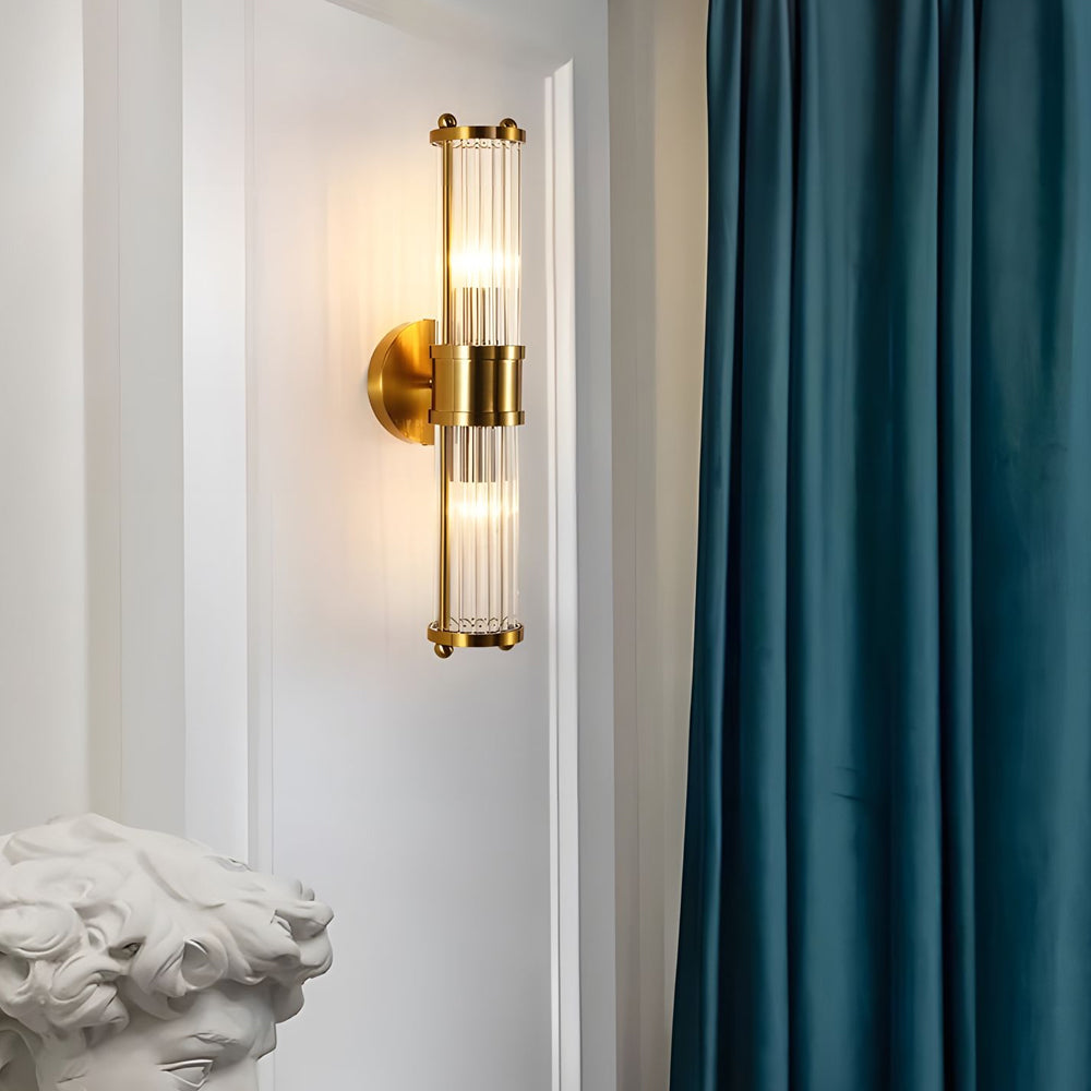 Modern wall lamp with cylindrical ribbed clear glass shade in chrome or gold finish