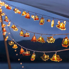 LED camping string lights with warm white tent and camper figures, battery operated