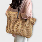 Women woven straw shoulder bag with firm top handle in natural texture