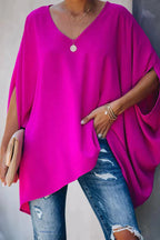 Women oversized tunic top with batwing sleeves and V-neckline, asymmetric hem