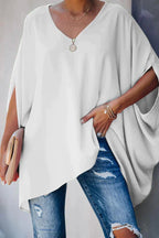 Women oversized tunic top with batwing sleeves and V-neckline, asymmetric hem