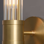 Modern wall lamp with cylindrical ribbed clear glass shade in chrome or gold finish