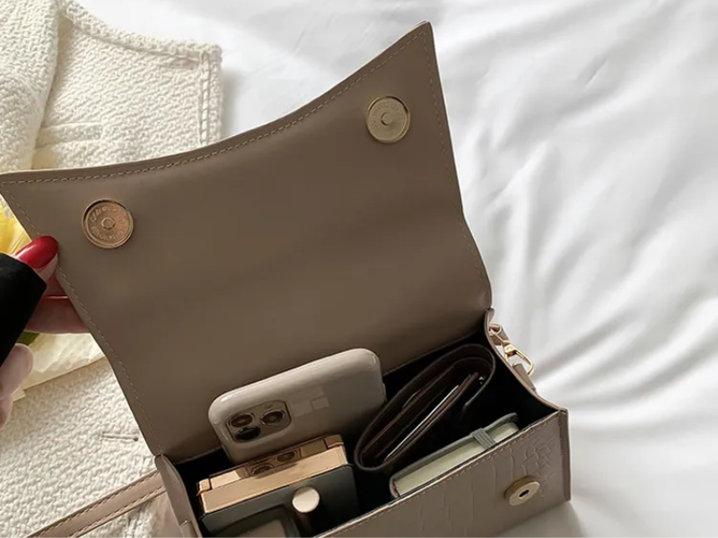 Women's PU leather handbag with top handle and crossbody strap, available in black and khaki