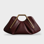 Clutch bag with origami folds and polished gold hexagonal handle in microfiber leather
