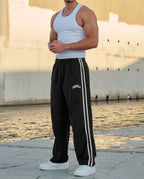 Men's striped track pants with elastic waist and zip pockets, athletic fit
