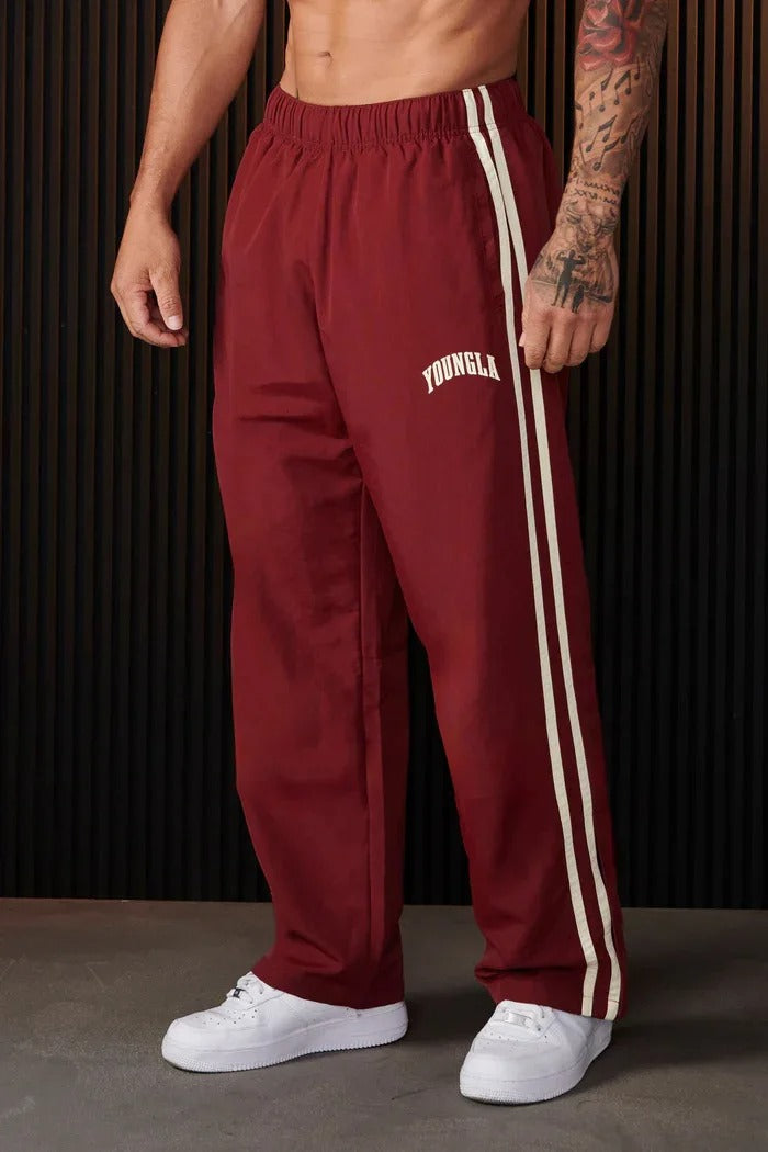 Men's striped track pants with elastic waist and zip pockets, athletic fit