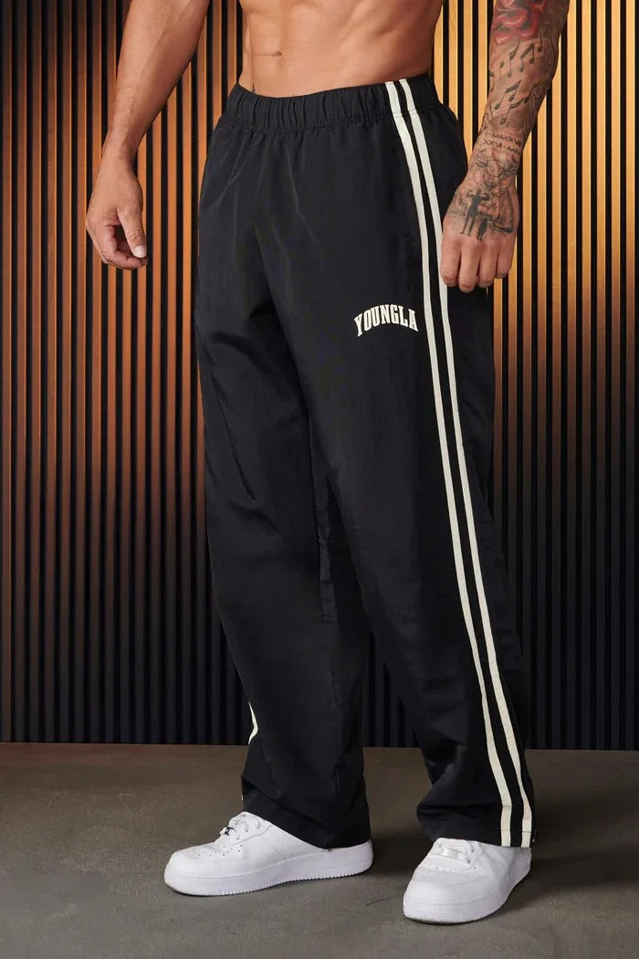 Men's striped track pants with elastic waist and zip pockets, athletic fit