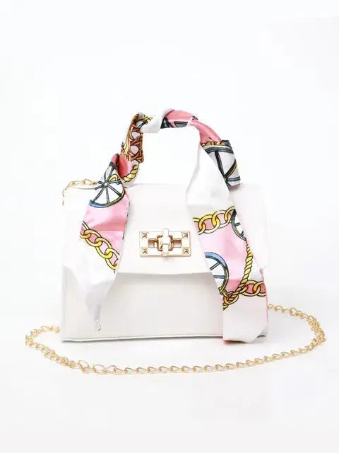 Women's brown leather handbag with gold clasp and scarf-wrapped handle