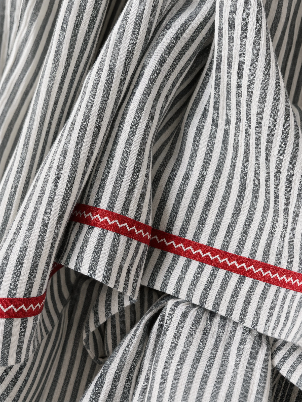 Women's striped maxi dress with spaghetti straps and red trim detail