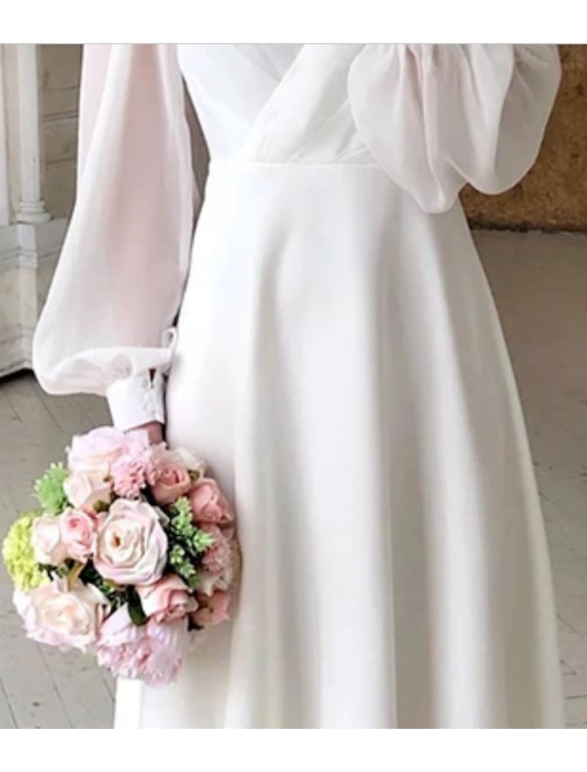 Women's white long sleeve flowing wedding dress with V-neckline, maxi bridal gown