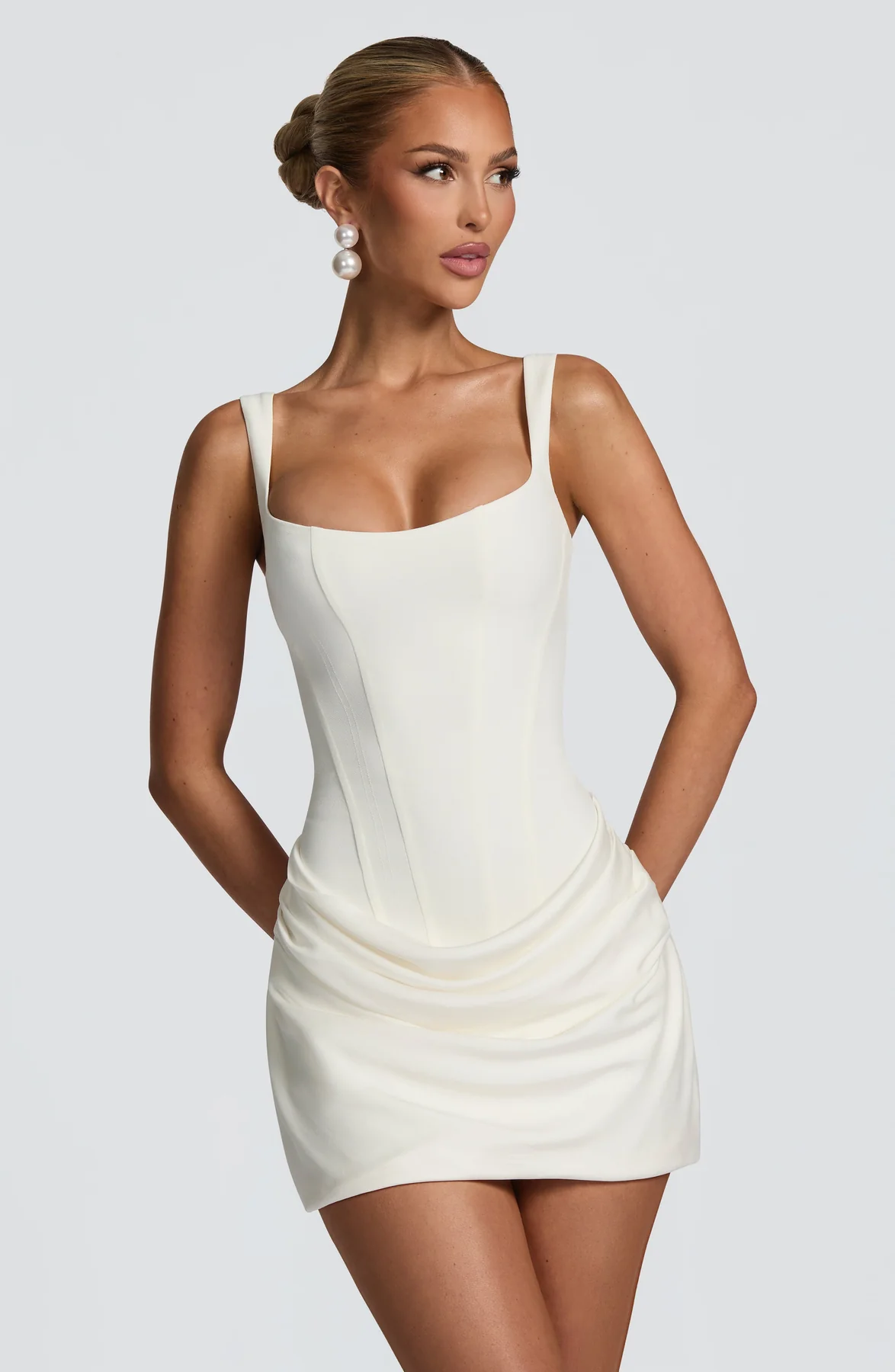 Women's mini dress with square neckline, draped skirt and lace-up back